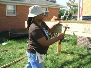 Senator Locke working on deck at Habitat house.